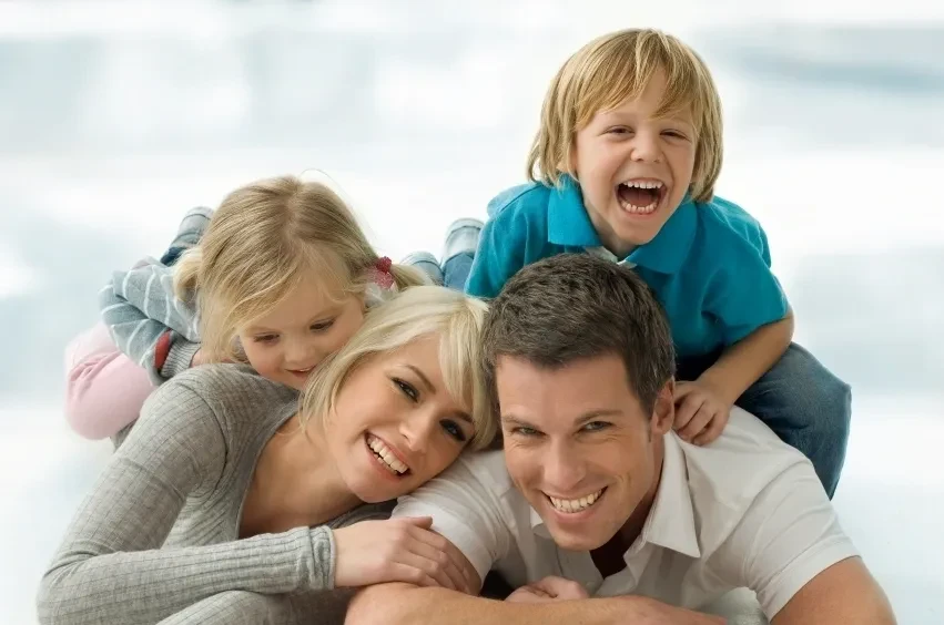 Happy family — parents and children laughing together